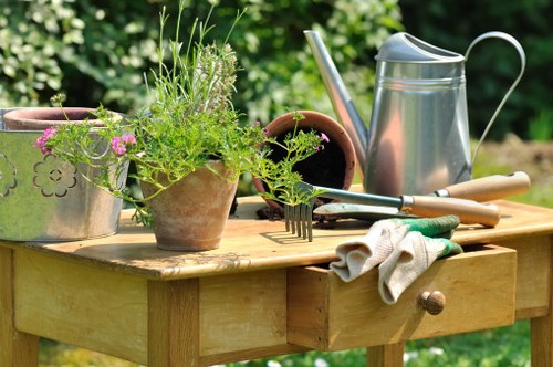 Gardener working in a Forest Hill garden with tools